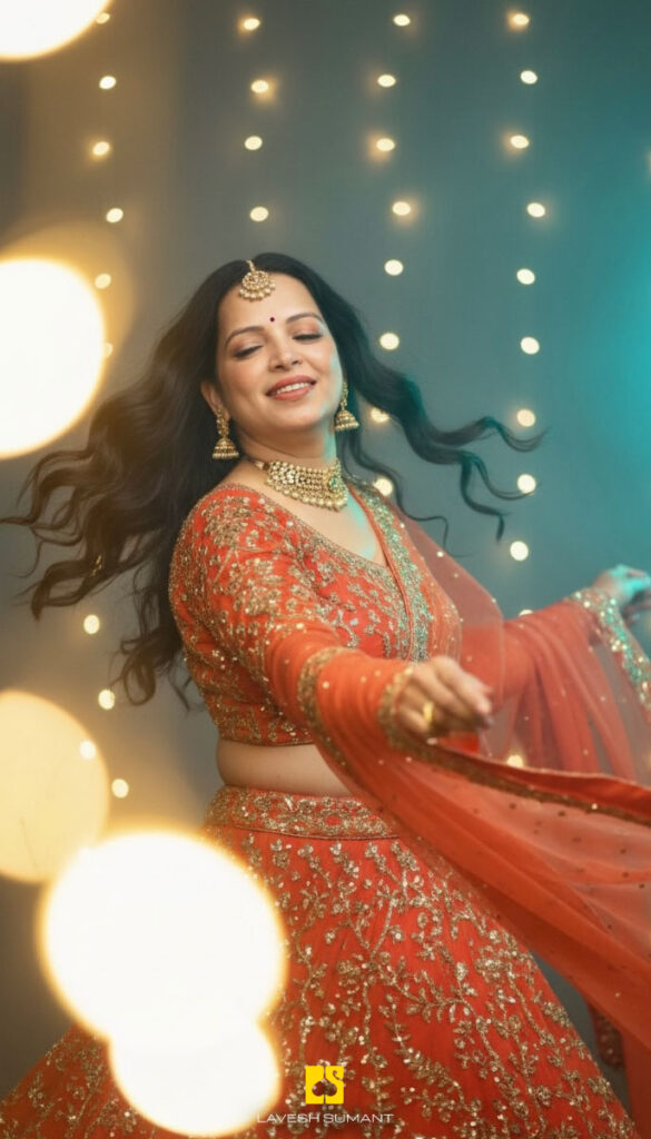 Woman dancing joyfully in a coral lehenga with flowing fabric and festive lights in the background
